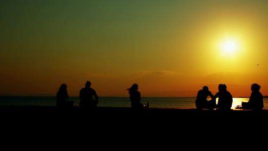 一群朋友在海滩上玩 逆光剪影