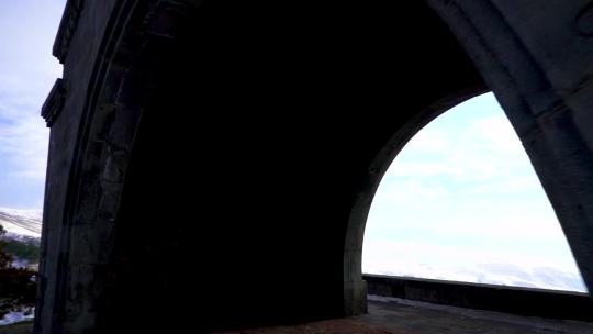 冬季日落时亚美尼亚查伦特拱门的剪影，可以看到雪帽