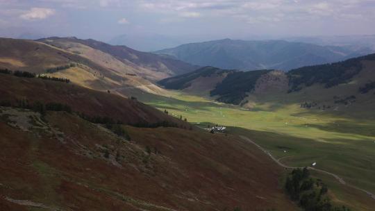 航拍新疆云彩投影在绿色的山谷中