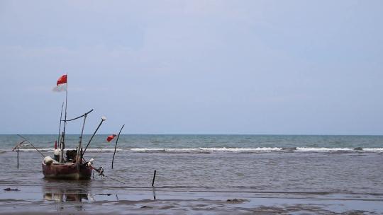 海滩上停泊的木船，因为渔民不出海，海浪是sw