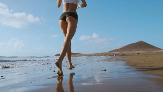 女人沿着沙滩跑步