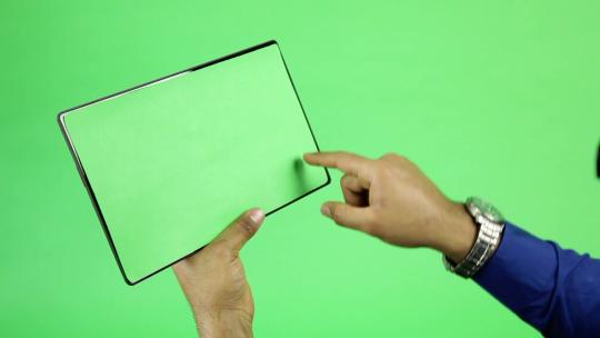 绿屏背景用手指触摸平板电脑