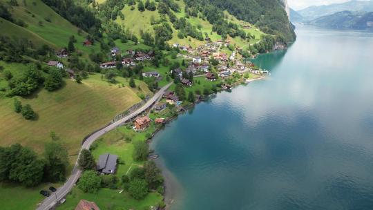 空中无人机镜头。飞越瑞士村庄和湖泊