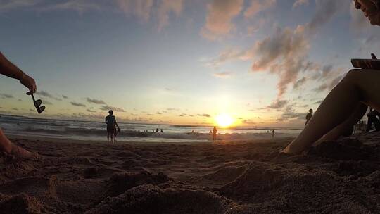 日落时分，人们聚集在海滩上  延时