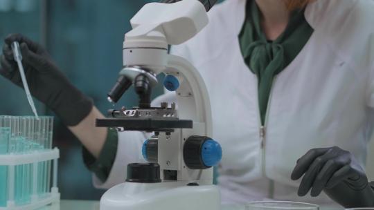 女科学家使用显微镜在测试试剂样本