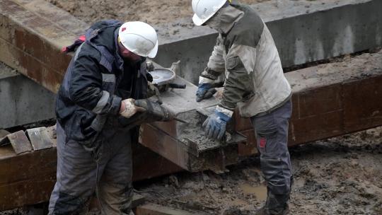 在建筑地盘用手提钻打磨建筑桩柱