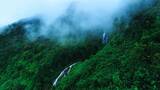 航拍绿色森林瀑布云海高清在线视频素材下载