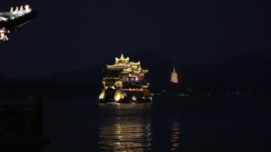 夜晚杭州西湖的游船背后是雷峰塔