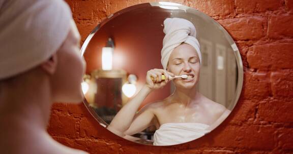 一个在镜子前刷牙的女人