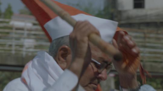 戴眼镜的男人扛着旗帜视频素材模板下载