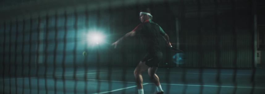 黑暗里打网球的男子