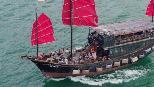 航拍香港维多利亚港红色帆船