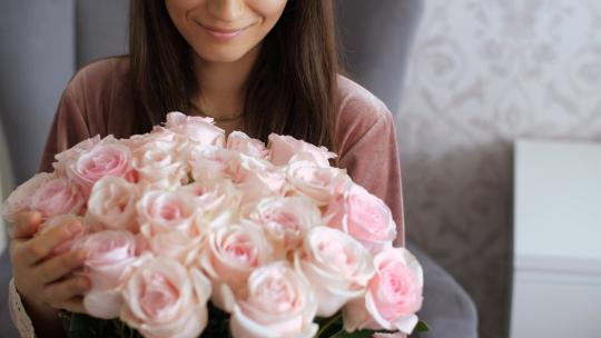 3709_快乐的女人捧着一束粉红色的花