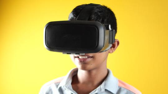 男孩戴着虚拟现实耳机VR盒视频素材模板下载