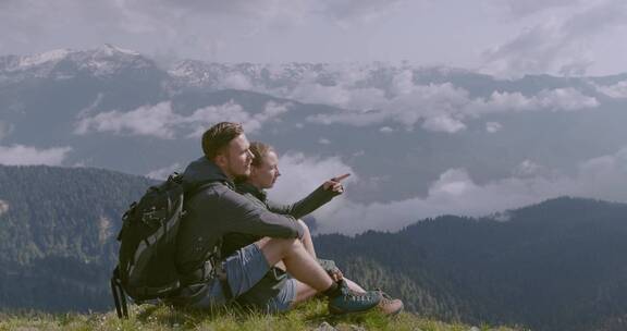 一对夫妇在山顶上欣赏风景