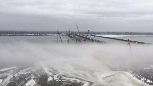 施工起重机在极端多雾的冬季天气拆除旧尚普兰桥，加拿大