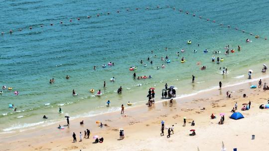 航拍广东惠州大亚湾黄金海岸游泳冲浪人群