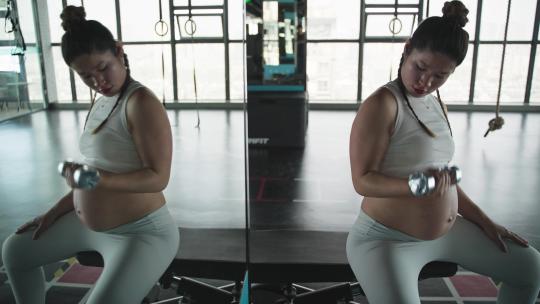 怀孕的现代女性在健身房锻炼身体