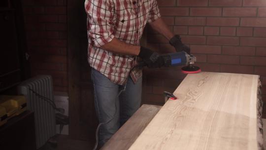男人正在打磨木板