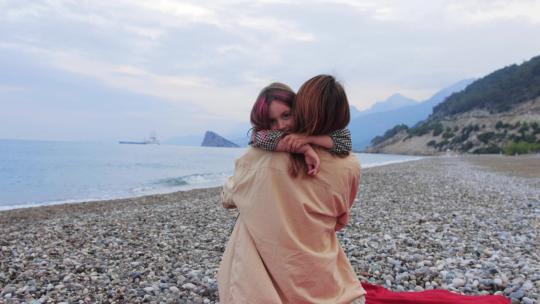 海边小女孩和妈妈拥抱