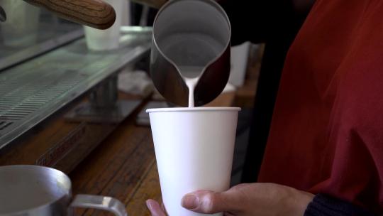 咖啡师准备咖啡的特写用牛奶制作拿铁艺术