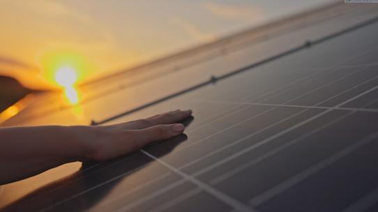 日落时手触摸太阳能电池板！