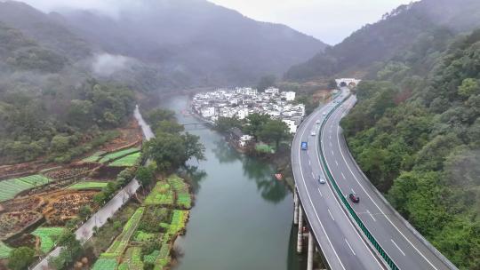 航拍江西婺源高速公路穿过徽派古民居上坦村