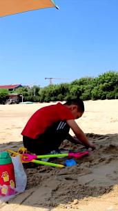 夏天沙滩男孩子玩沙竖版高清