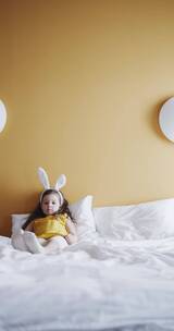 一个女孩躺在床上戴着兔子发带玩