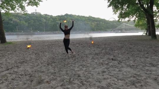 在沙滩上表演火球杂技的女人慢镜头视频素材模板下载