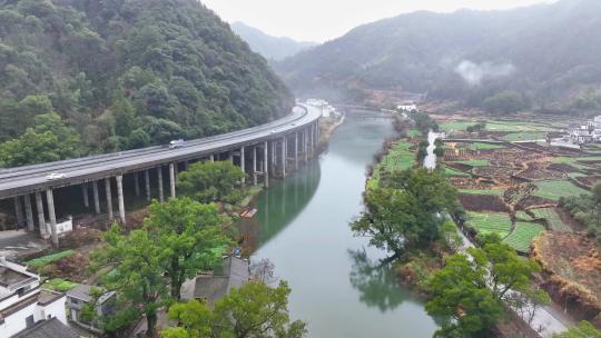 航拍江西婺源高速公路穿过徽派古民居上坦村