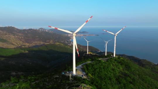 航拍风力发电设备山脉海边