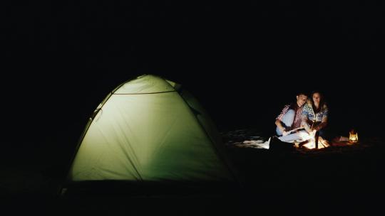 情侣露营晚上在篝火旁