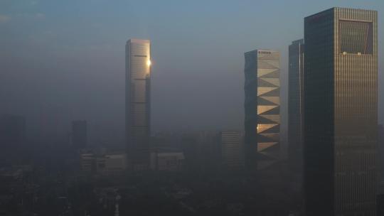 航拍早晨雾霾中的城市高楼